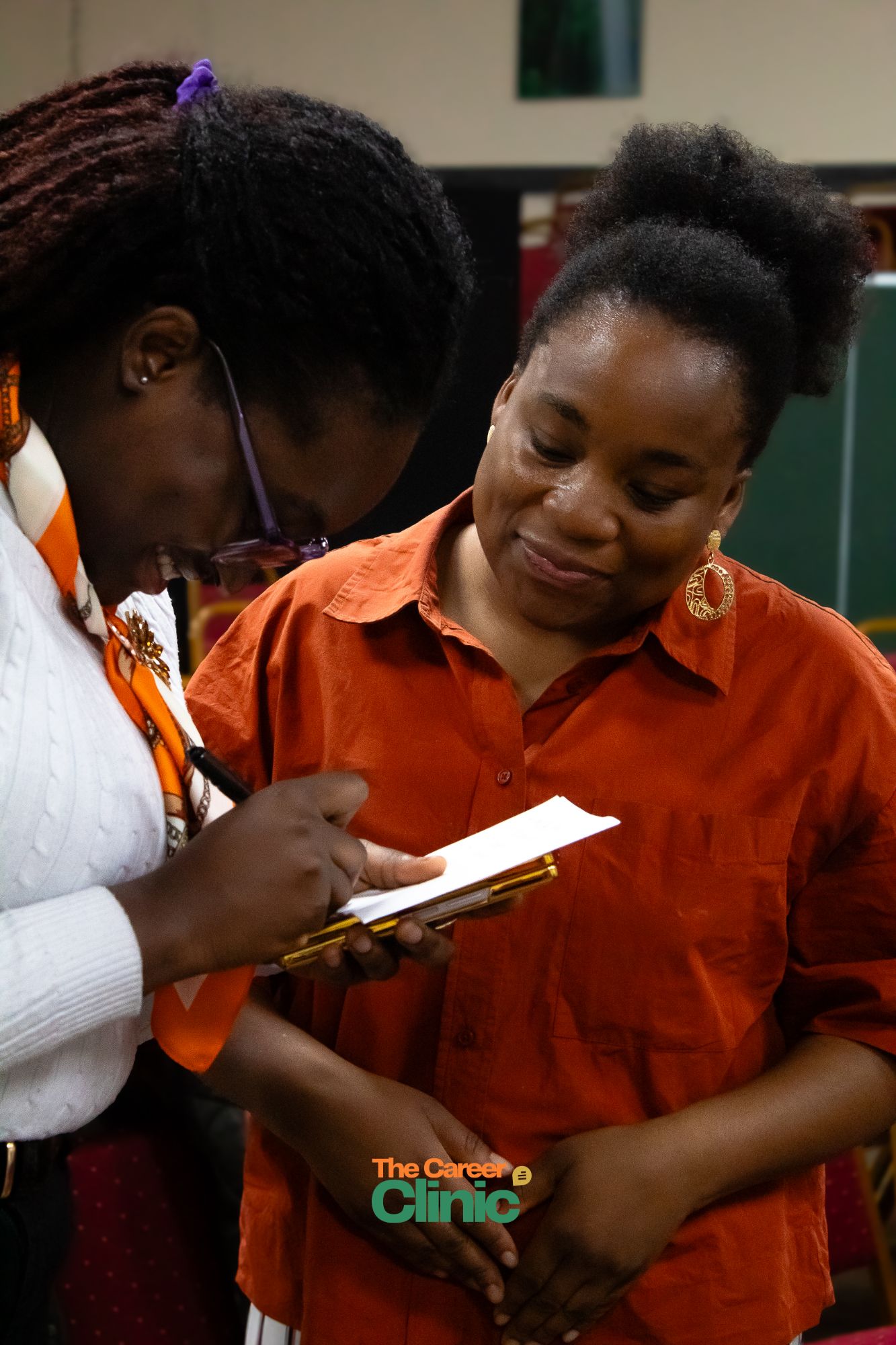 Two attendees reviewing notes during a consultation