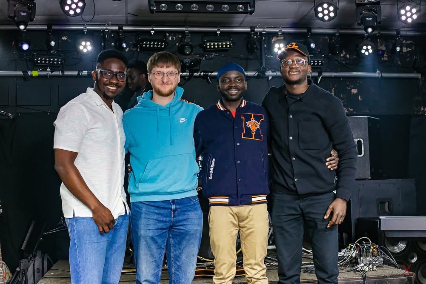Collaborators on a music venue stage